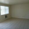 Remodeled Living Room with new windows, floor tile and air conditioner.