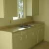 Remodeled Kitchen wit new flooring, cabinets, countertop, window and sink.